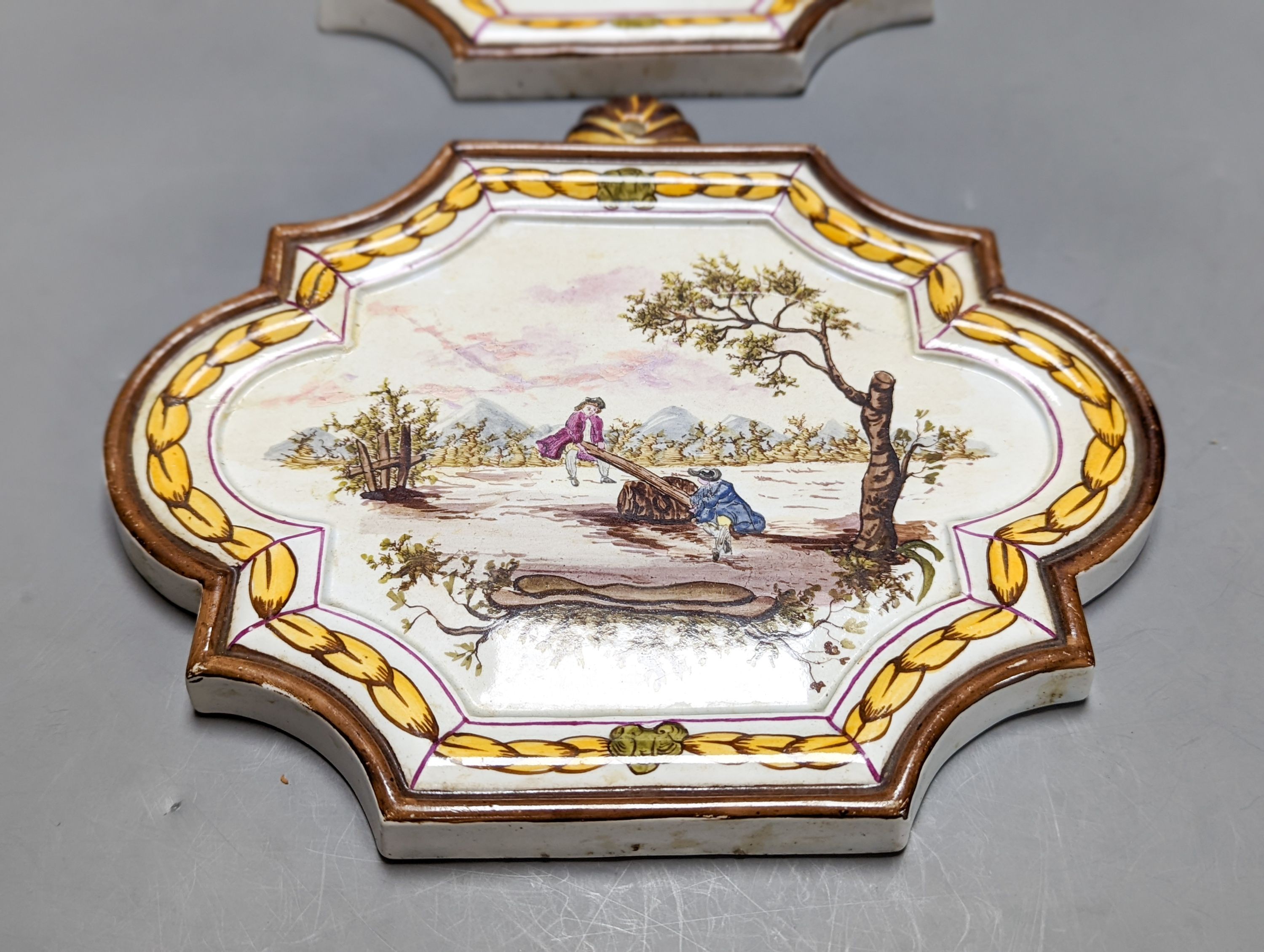 A pair of 19th century painted faience plaques in the style of Veuve Perrin 23cm